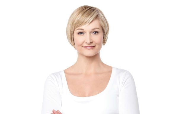 woman with short hair wearing a white long sleeve shirt
