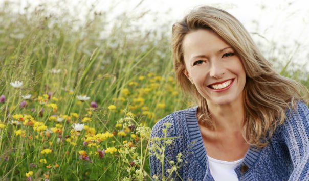 woman sitting in a field of flowers