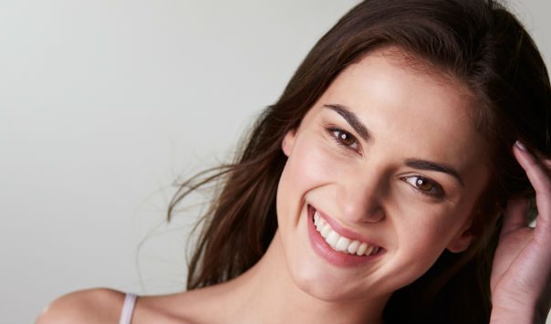 woman with long dark hair smiling