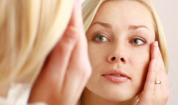 woman looking at herself in the mirror