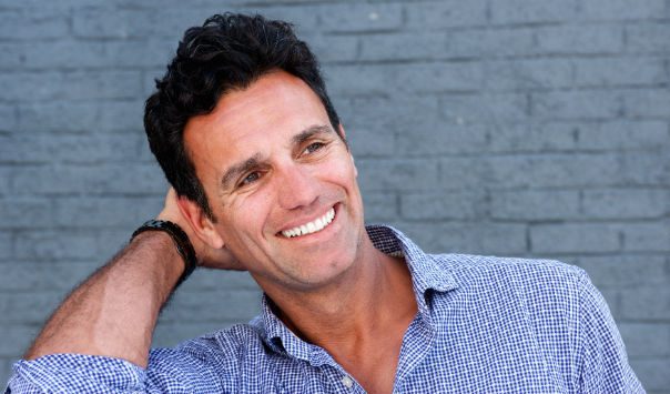 man wearing a blue shirt smiling